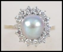 A 14 ct gold pearl and diamond ring with central grey pearl surrounded by approx 70pts halo of