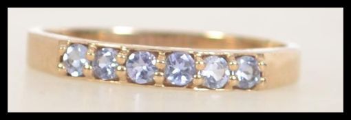 9ct gold 6 stone ring set with amethyst stones. Weight 2.6g. Size S.