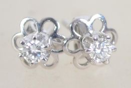 A pair of ladies white gold and diamond earrings - studs complete with the posts,