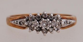 A 9ct gold and diamond cluster ring. Approx 20pts diamonds. Hallmarked Birmingham. Size M.