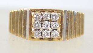 A hallmarked 18ct gold and diamond ring with ribbed tapering shoulders in the manner of Rolex with