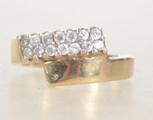 A 9ct gold hallmarked Birmingham dress ring set with clear pave set stones in an overlapping twin