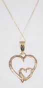 A 9ct gold heart pendant necklace and chain. The fine linked chain with interlocking heart pendants.
