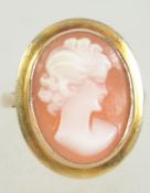 A hallmarked mid century 9ct gold ring with oval set cameo mounted within a stepped gallery and