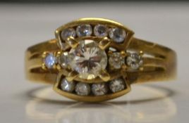 An 750 gold and diamond ring set with central 20pt diamonds total approx 40pts. Marked 750.