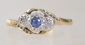 An 18ct gold, sapphire and diamond ring. The central sapphire flanked by diamonds in star settings.