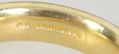 A hallmarked contemporary 18ct gold and diamond band ring,