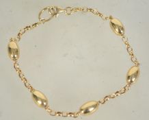 A hallmarked Italian 14ct gold drop link bracelet. Hallmarked Birmingham. Measures 7.5 inches.