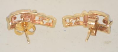 A pair of 9ct gold Art Deco style earrings set with clear stones and post backs. Measures 1.5cms.