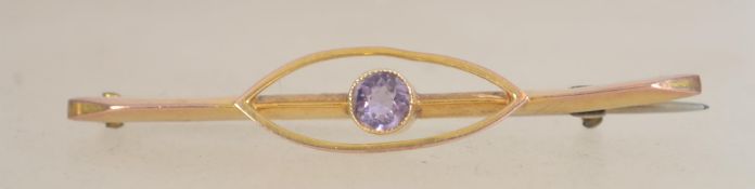 A 9ct gold Art Deco bar brooch with bezel set amethyst with c clasp.