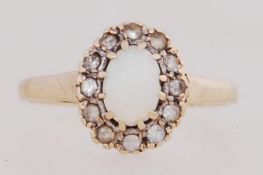 A 9ct gold cluster ring set with opal and a halo of CZ. Hallmarked Birmingham. Size P.