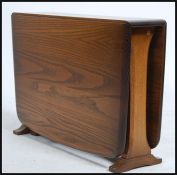 A 20th century ' Golden Dawn ' Ercol elm wood drop leaf side / coffee table. The table raised on