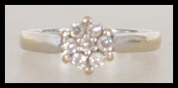A hallmarked 18ct white gold diamond cluster ring