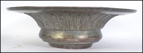 An Islamic chased copper bowl, 19th century, the t
