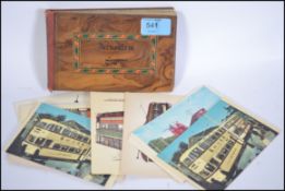 An early 20th century olive wood postcard album ha