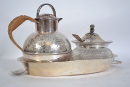 A silver plated oval salver tray with glass and si