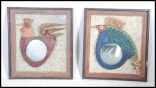 A pair of unusual painted metal mirrors in the for