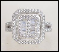 A silver ring set with baguette cut CZ stones. Siz