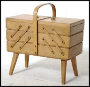 A retro 1950's metamorphic sewing box of beechwood