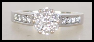 A 14ct white gold and diamond ring, the large cent