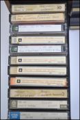 A collection of assorted musical cassette tapes wi