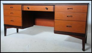 A 1970's retro teak wood writing table desk raised