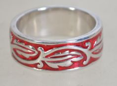 A silver 925 band ring with inset red painted back