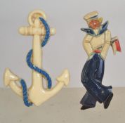 A pair of vintage celluloid brooches one being in the form of a jolly sailor with painted features