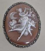 An early 20th century silver and marcasite shell cameo brooch / pendant depicting a maiden and