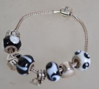 A Miss Rhoana Sutton silver 925 charm fox tail bracelet with black and white ball charms, silver