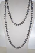 A vintage long freshwater black pearl hand knotted string necklace measuring 120cms long.