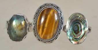 A group of three silver 925 dress rings to include one set with a large central tigers eye stone,