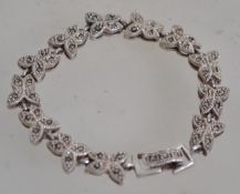 A silver 925 and marcasite vintage butterfly link bracelet having a fold over clasp. Measures 17.5