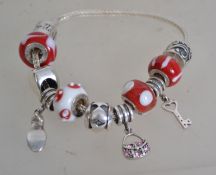 A Miss Rhoana Sutton silver 925 charm fox tail bracelet with red and white ball charms, silver heart
