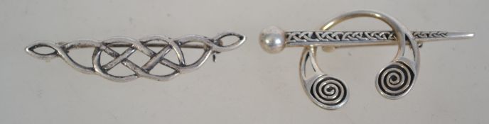 Two silver 925 brooches one being a Celtic knot bow brooch and the other being a Celtic cloak pin