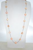 A vintage silver and mother of pearl long statious necklace being rolo linked with mother of pearl
