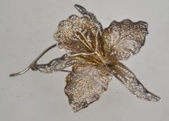 A fantastic pierced fretwork filigree silver brooch in the form of a cymbidium orchid having a