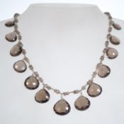 A silver 925 and smokey quartz with lobster claw clasp having small smokey quartz spacers with