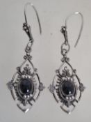 A pair of early 20th century Art Deco style silver drop pierced earrings with onyx cabochons. Marked