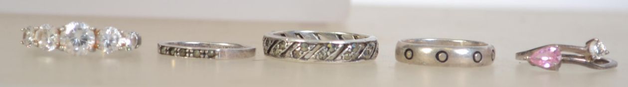 A group of 5 silver 925 ladies dress rings to include one with 5 round cut clear stones, a band ring