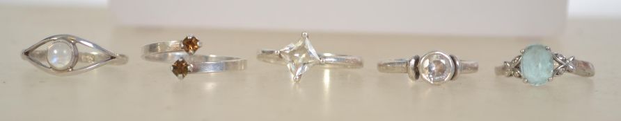 A group of 5 silver 925 ladies rings to include one having a cross over setting with orange garnet