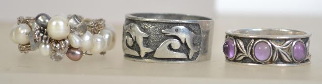 A silver 925 ladies band ring with leaf pattern set with purple stones along with another silver