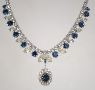 A 1905s rhinestone demi-parure of necklace and clip earrings in silver tone setting settings with