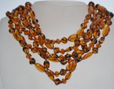 A vintage amber style glass bead 6 string necklace, stamped and logo marked Givenchy with gold