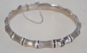 A designer hallmarked 925 silver bone link bracelet bangle with hidden clip clasp and safety chain