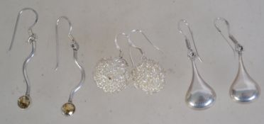 Three pairs of silver 925 earrings to include a silver wire ball pair, a wave design pair with