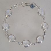 A silver 925 rolo link bracelet having moonstone spacers and c clasp. Weighs 11.9 grams and measures