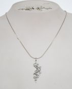 A silver 925 snake link necklace chain with spring hoop clasp having a silver lizard / dragon drop