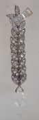 An Art Deco articulated silver and rhinestone fob brooch with crystal drop and C loop clasp.