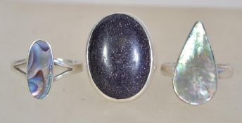 A group of three silver 925 dress rings to include a ring with a large mother of pearl tear drop